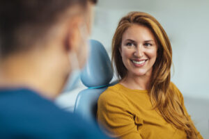 Woman listening to her dentist about bone grafting