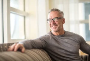 Man sitting on a sofa smiling