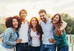 Group of friends smiling while in a group hug