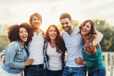 Group of friends smiling while in a group hug